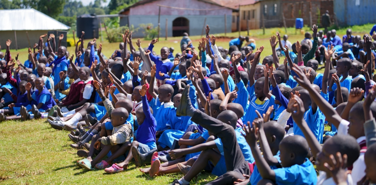Happy_African_Students_Sitting_and_Raising_Hands