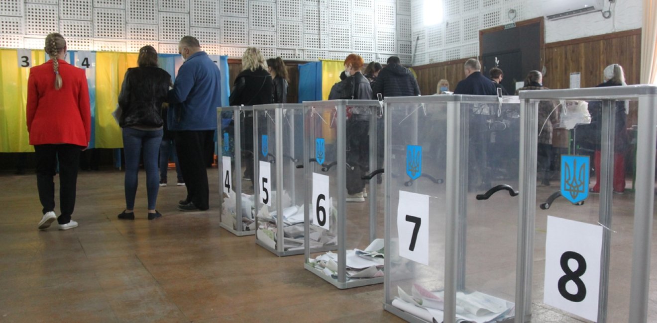 ODESSA, UKRAINE -25.10.2020 - Elections in Ukraine. Electoral platform for elections of local councilors during the COVID-19 coronavirus pandemic. People wearing masks and gloves with voting ballots