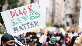 Protests in New York. People with protesting posters marching protest over George Floyd death. Black lives matter movement in New York. 