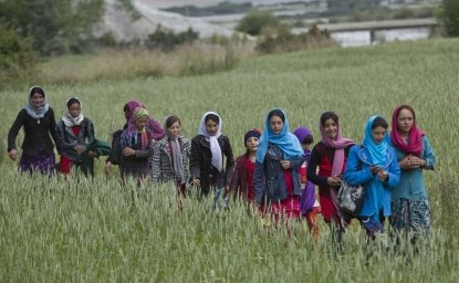 In this Thursday, Aug. 18, 2016 photo, young girls walk towards their school, in Wakhan, Badakhshan province, far northeastern Afghanistan.