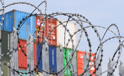 Shipping Containers behind Razor Wire