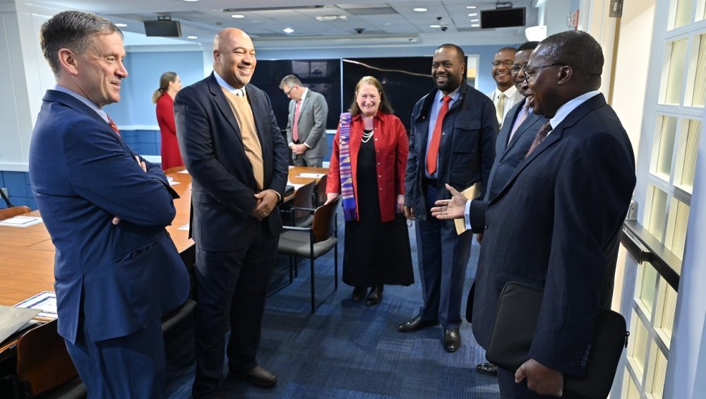 Ambassador Mark Green, Dr. Nancy Walker, and Michael Forster greet H.E. Ambassador Muchanga