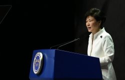 Park Guen-Hye speaking at a podium.