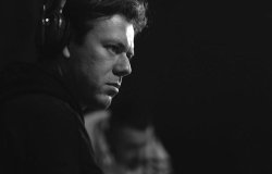 Black and white photo of man in profile wearing headphones
