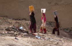 Women carrying water in Kabul, Afghanistan