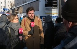 Image of two reporters with microphones 