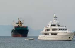 Cargo transport ship and motor yacht are going to marine port of the Red Sea