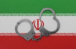Iranian flag with partially opened handcuffs 