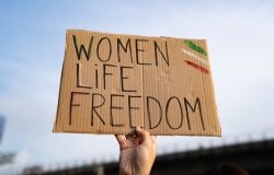 Protest sign reading "Women, Life, Freedom"