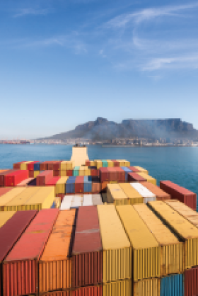 Large stacked container ship leaving the port of Cape Town with Table mountain and the city in the background, South Africa.